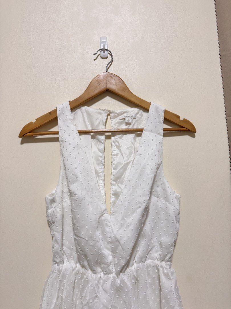 White Romper (Category: Rompers) located in Manila. Submitted by seayouncey (Listing ID 1470061547, Image 3). Description: - Brand: Kookai - Size: 36 (Small) - Color: Classic White - Fabric: Textured Swiss dot with full lining - Design: Sleeveless, deep crossover V-neck, layered ruffled waist - Back Details: Open back cutout with top button closure - Condition: Excellent / Like new.