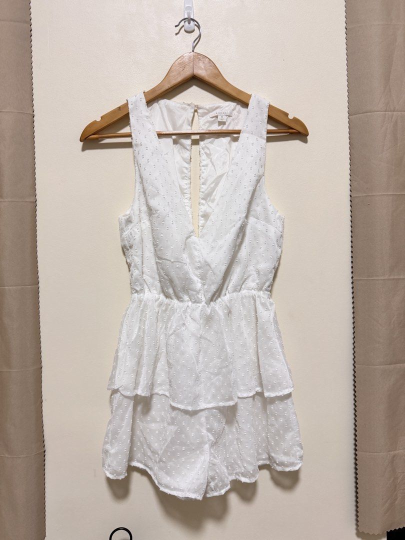 White Romper (Category: Rompers) located in Manila. Submitted by seayouncey (Listing ID 1470061547, Image 1). Description: - Brand: Kookai - Size: 36 (Small) - Color: Classic White - Fabric: Textured Swiss dot with full lining - Design: Sleeveless, deep crossover V-neck, layered ruffled waist - Back Details: Open back cutout with top button closure - Condition: Excellent / Like new.