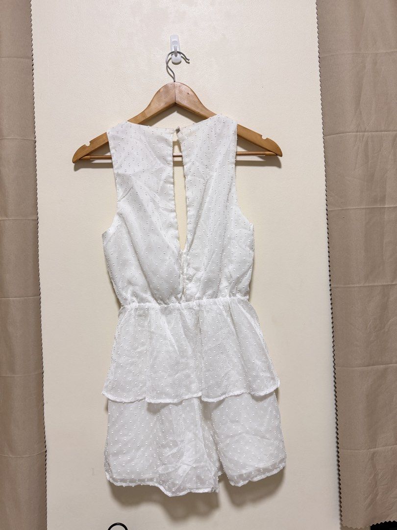 White Romper (Category: Rompers) located in Manila. Submitted by seayouncey (Listing ID 1470061547, Image 2). Description: - Brand: Kookai - Size: 36 (Small) - Color: Classic White - Fabric: Textured Swiss dot with full lining - Design: Sleeveless, deep crossover V-neck, layered ruffled waist - Back Details: Open back cutout with top button closure - Condition: Excellent / Like new.