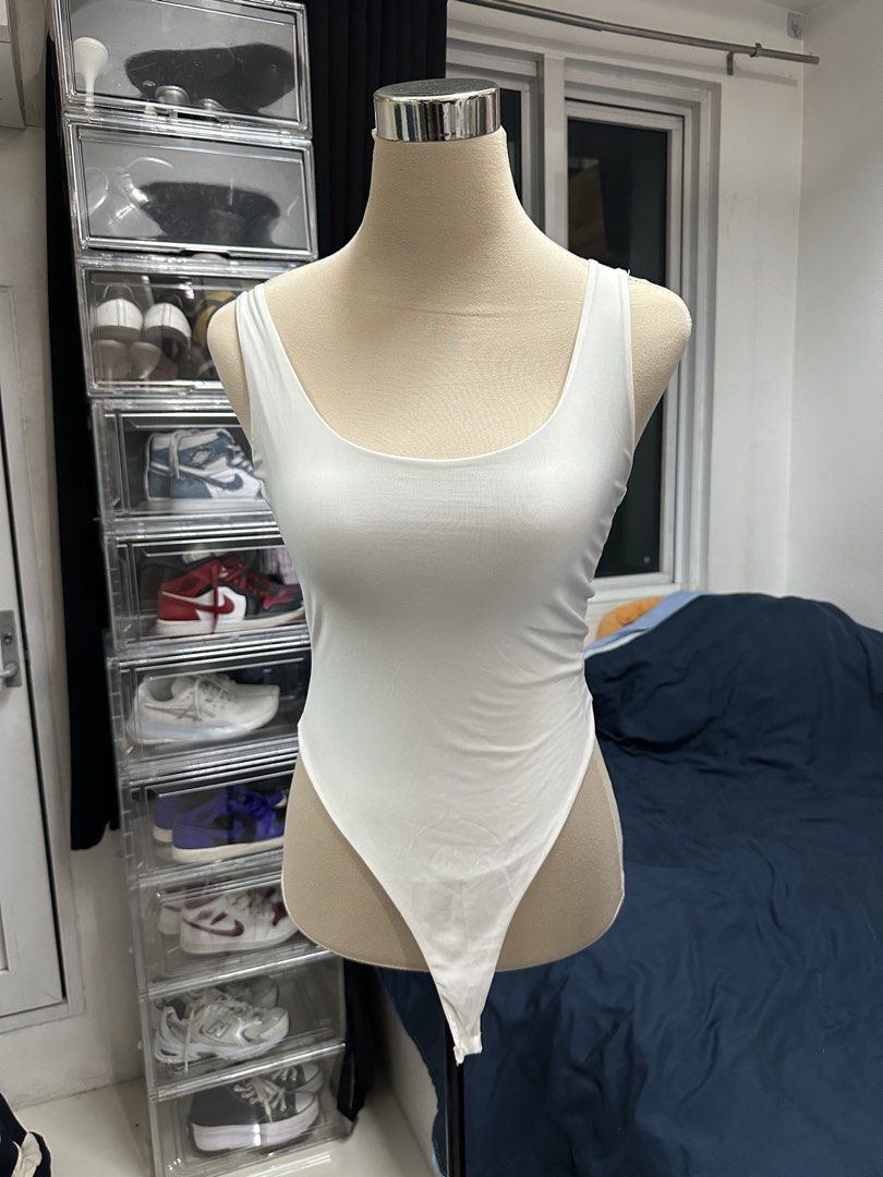 White scoop neck sleeveless bodysuit (Category: Sleeveless) located in Quezon City. Submitted by valeriorac74670 (Listing ID 1470045387, Image 1). Description: - Color: Plain white - Style: Scoop neckline, sleeveless, high-cut leg opening - Fit: Body-hugging, made from stretchy knit fabric - Versatility: Easy to pair with high-waisted jeans or skirts.