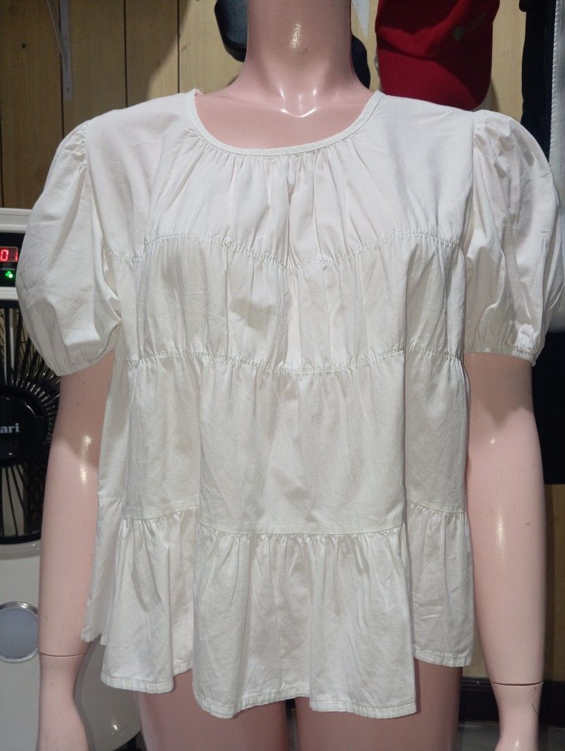 White Tiered Short Sleeve Blouse Peasant Top (Category: Blouses) located in Cebu City. Submitted by smnthdanielle (Listing ID 1470128475, Image 2). Description: - Color: White - Style: Casual short sleeve blouse with tiered design and gathered details - Neckline: Round neckline - Sleeves: Trendy puffy sleeves - Fit: Soft fabric that falls loosely for comfort - Pairing: Easy to match with shorts or skirts for warm weather outings.