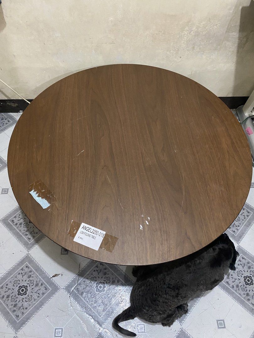 Wood Round Table 🏷️🏷️ (Category: Tables & Sets) located in Quezon. Submitted by odd.theprelovedhub (Listing ID 1469978693, Image 3). Description: Wood Round Table 🏷️🏷️ • Color: Dark Brown • Material: Natural Wood Fiber Wood • Dimensions: (Width 900 × Height 350 mm) • Folding Leg • With visible sign of use Folding Instructions- Push the lock on the leg mounting hardware while folding the leg down in the direction of the arrow until it locks se