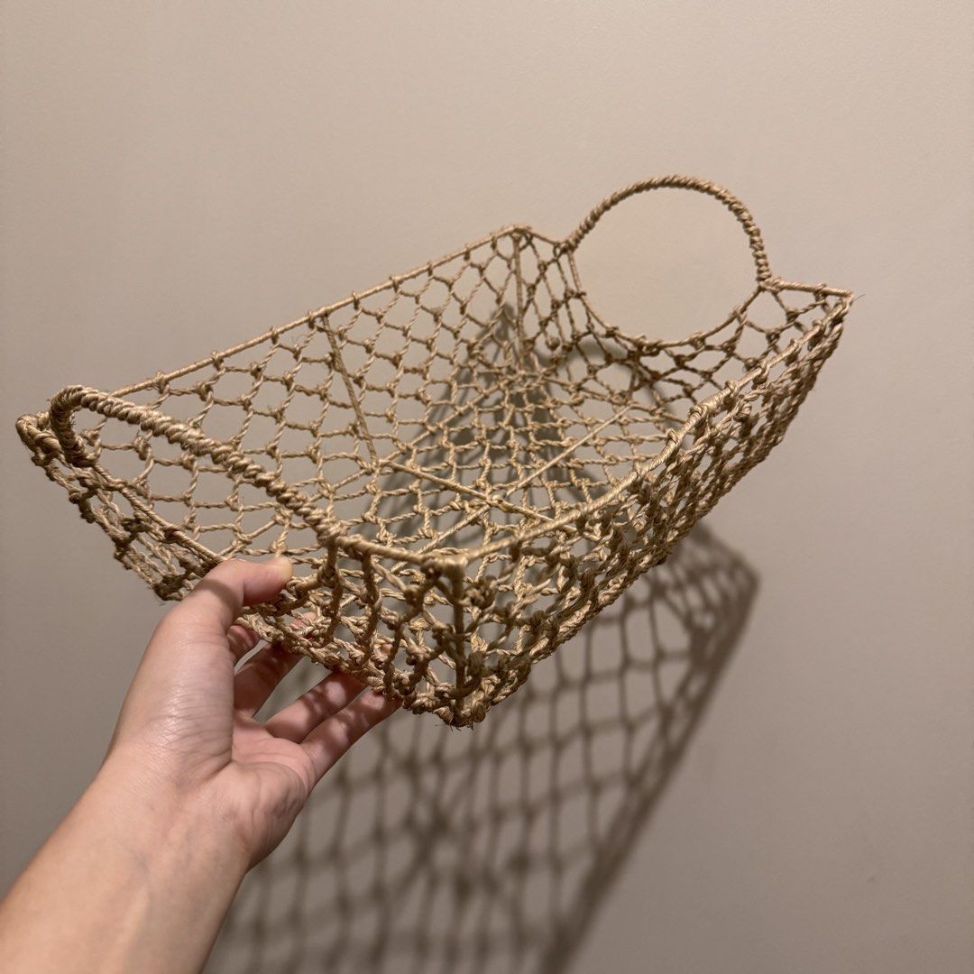 Woven jute storage basket with circular handles (Category: Storage Boxes & Baskets) located in Quezon City. Submitted by ianne.declutter (Listing ID 1470049511, Image 1). Description: - Material: 100% natural jute rope in a neutral beige tone - Design: Rectangular shape with an open mesh weave - Features: Sturdy circular handles on both ends for easy carrying - Versatile: Ideal for organizing living room shelves, bathroom toiletries, or kitchen p