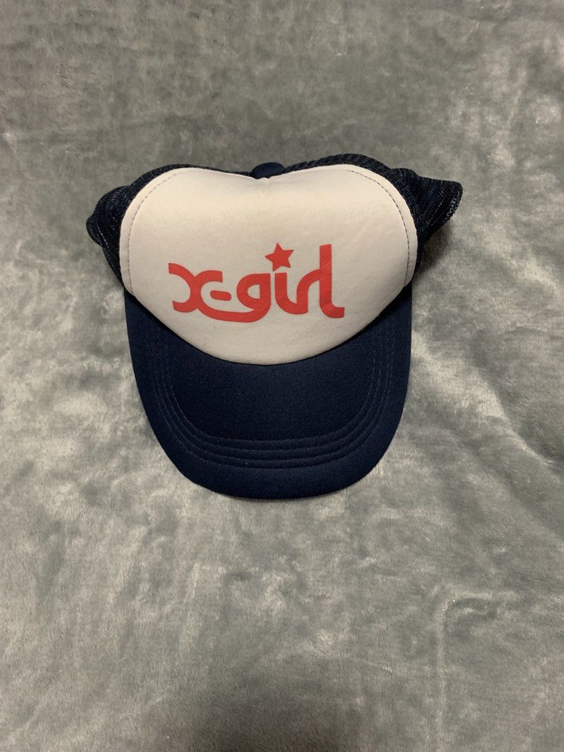 X-Girl Trucker Hat Navy White Red (Category: Caps & Hats) located in Las Pinas. Submitted by jerkasfvc (Listing ID 1470074744, Image 1). Description: - Brand: X-girl - Design: Navy blue brim/mesh back with white foam front panel - Logo: Bold red X-girl graphic with star dot - Style: Vintage Y2K skater / streetwear - Fit: Adjustable snapback closure - Condition: Clean and ready to wear.