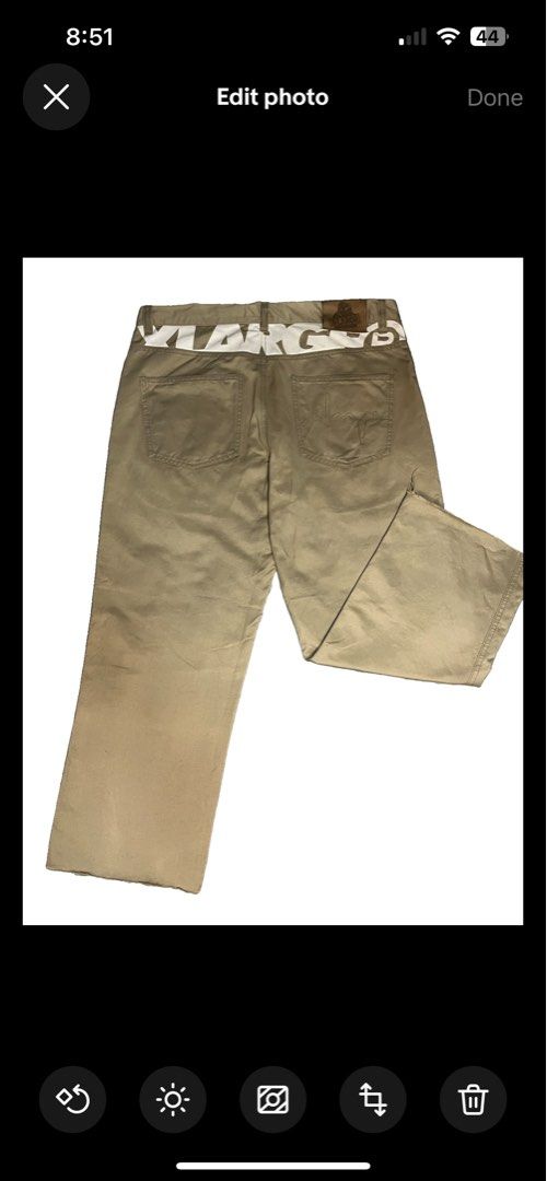 XLarge Beige Chino Pants Size 34 (Category: Chinos) located in Muntinlupa City. Submitted by pastforwardthrift (Listing ID 1470125485, Image 2). Description: - Size: XLarge (Fits waist size 34) - Color: Neutral khaki / tan - Fit: Straight leg cut - Details: Bold white branding on back waistband, logo-stamped metal button - Accent: Leather patch with gorilla graphic on back pocket - Style: Essential streetwear staple.