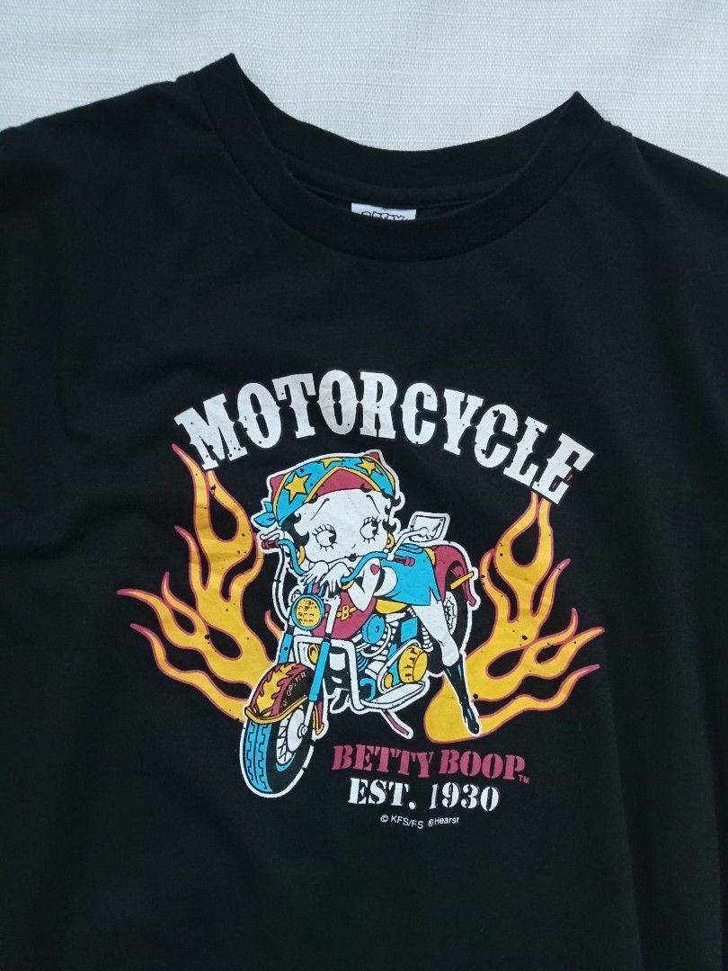 Y2k Betty Boop flame graphic tee (Category: Shirts) located in Bagabag. Submitted by thrift_stories96 (Listing ID 1470119488, Image 2). Description: Y2k Betty Boop flame graphic tee Medium Length - 23 Width - 18.5 Condition - excellent No flaw.