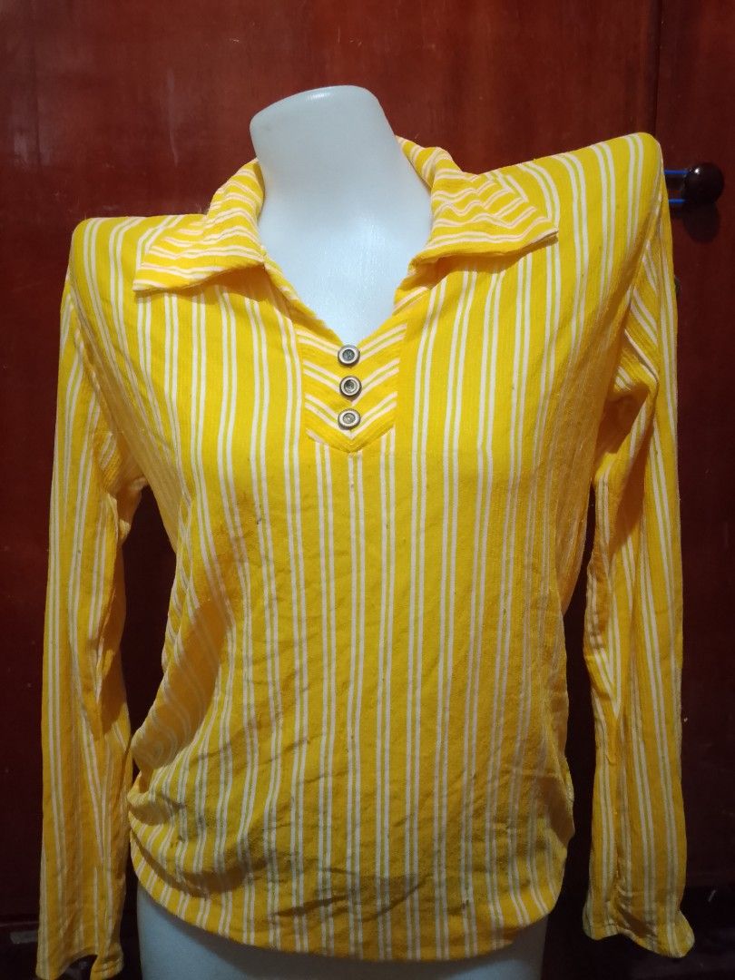 Yellow striped long sleeve polo blouse (Category: Longsleeves) located in Batangas. Submitted by sheenx.09 (Listing ID 1470095026, Image 1). Description: - M - Color: Bright yellow with white vertical stripes 🫶 - Material: Soft and comfortable knit fabric ♥️ - Design: Long sleeves, collared neckline with V-cut placket, and three decorative buttons 🥰 - Style: Great for casual daily outfits and effortless styling - Fit: Comfortable regular fit.