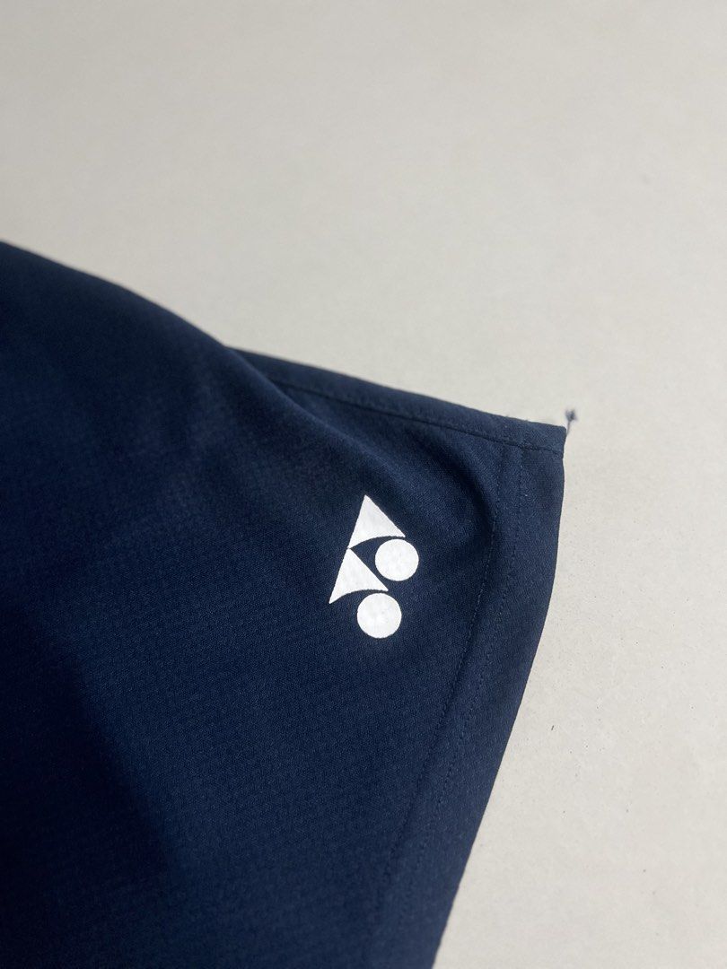 Yonex Navy Blue Athletic Shorts with Drawstring (Category: Shorts) located in Tacloban City. Submitted by thrftg (Listing ID 1470086386, Image 2). Description: - Brand: Yonex - Color: Dark Navy Blue - Material: Lightweight, breathable mesh-style fabric - Features: Elastic waistband with adjustable black drawstring - Branding: Vertical white Yonex logo on the left leg and smaller logo on the right hem - Ideal for: Badminton, tennis, and other spor