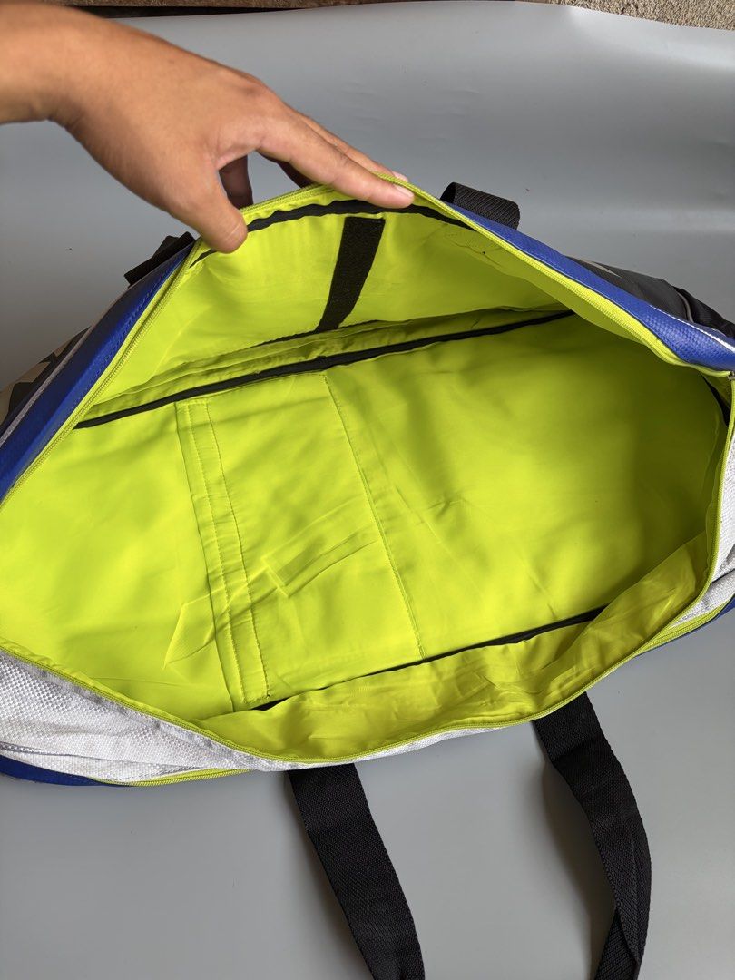 Yonex Pro Badminton Bag Blue Black (Category: Racket and Ball Sports) located in Kibawe. Submitted by jeloots (Listing ID 1469999545, Image 2). Description: - Authentic Yonex Pro sports bag in a sleek black and blue colorway with a bold front logo - Eye-catching neon yellow interior lining with multiple compartments for organized gear storage - Equipped with dual carry handles and a secure side buckle closure - Crafted from rugged, durable materi