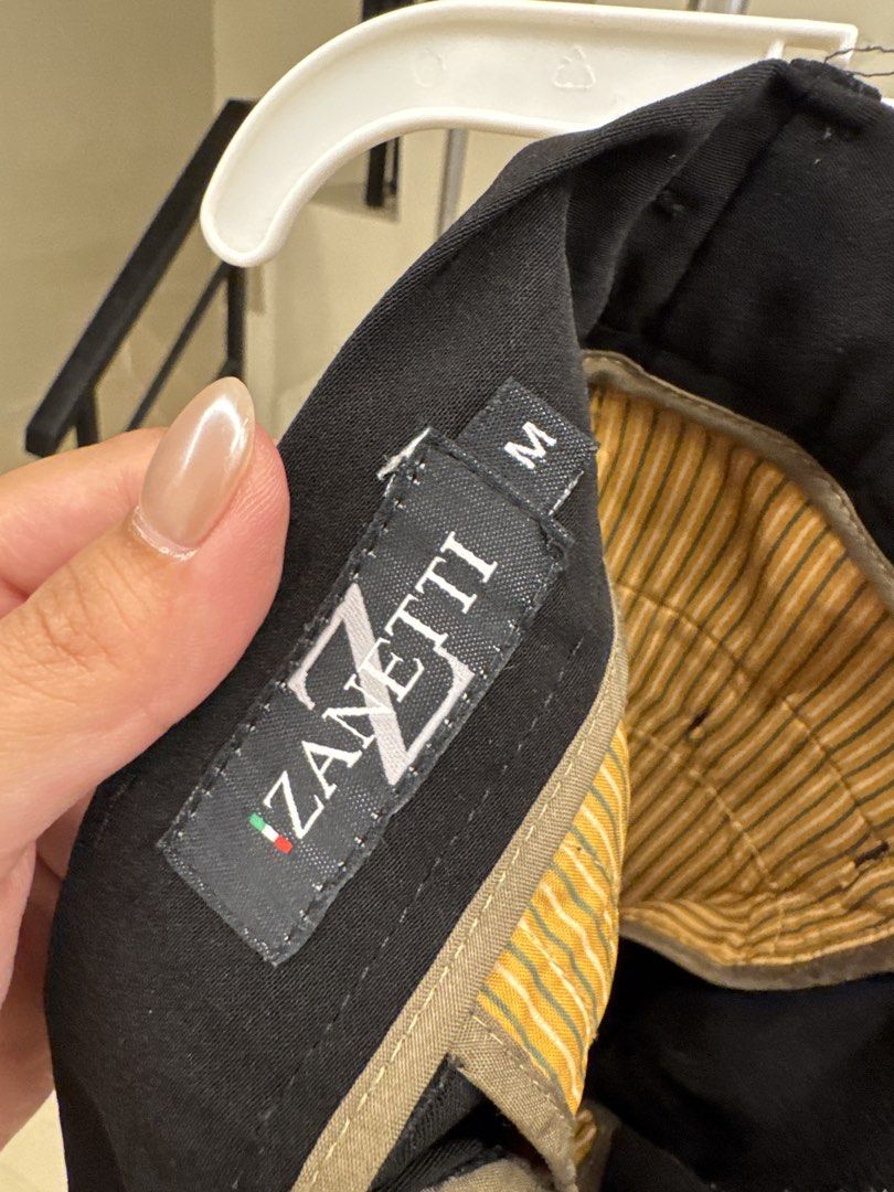Zanetti Black Trousers Size M (Category: Babies & Kids Fashion) located in Manila. Submitted by __nix (Listing ID 1470019938, Image 3). Description: - Brand: Zanetti - Size: M - Color: Classic Black - Features: Belt loops, front pockets, button-closure back pockets - Special Detail: Striped inner waistband lining - Style: Versatile staple for smart casual or formal outfits - Matching: Easy to pair with shirts and blazers.