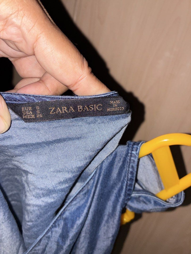 Zara Basic Denim Romper Size S (Category: Rompers) located in Placer. Submitted by talaalond61563 (Listing ID 1469986308, Image 3). Description: - Brand/Item: Zara Basic Denim Romper - Color: Blue - Size: S (Tag) - Fits up to Large - Material: Lightweight denim, very comfortable - Features: Sleeveless, crossover front, elasticated drawstring waist - Origin: Made in Morocco.