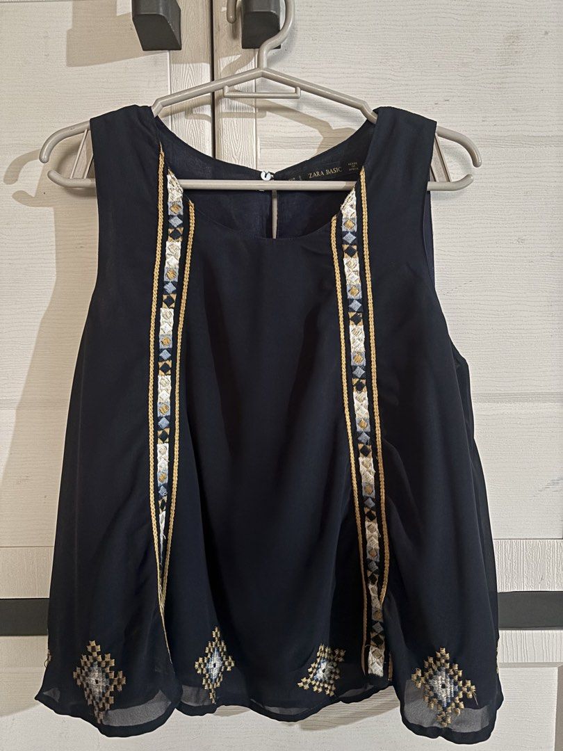 Zara Basic Navy Embroidered Sleeveless Top Size S (Category: Sleeveless) located in Antipolo. Submitted by jennibee (Listing ID 1469986914, Image 1). Description: - Brand/Model: Zara Basic - Size: S - Color: Navy blue with blue, white, and gold embroidery - Material: Lightweight chiffon - Details: Sleeveless, geometric embroidery on front and bottom hem, back keyhole cutout with button closure - Condition: Excellent.