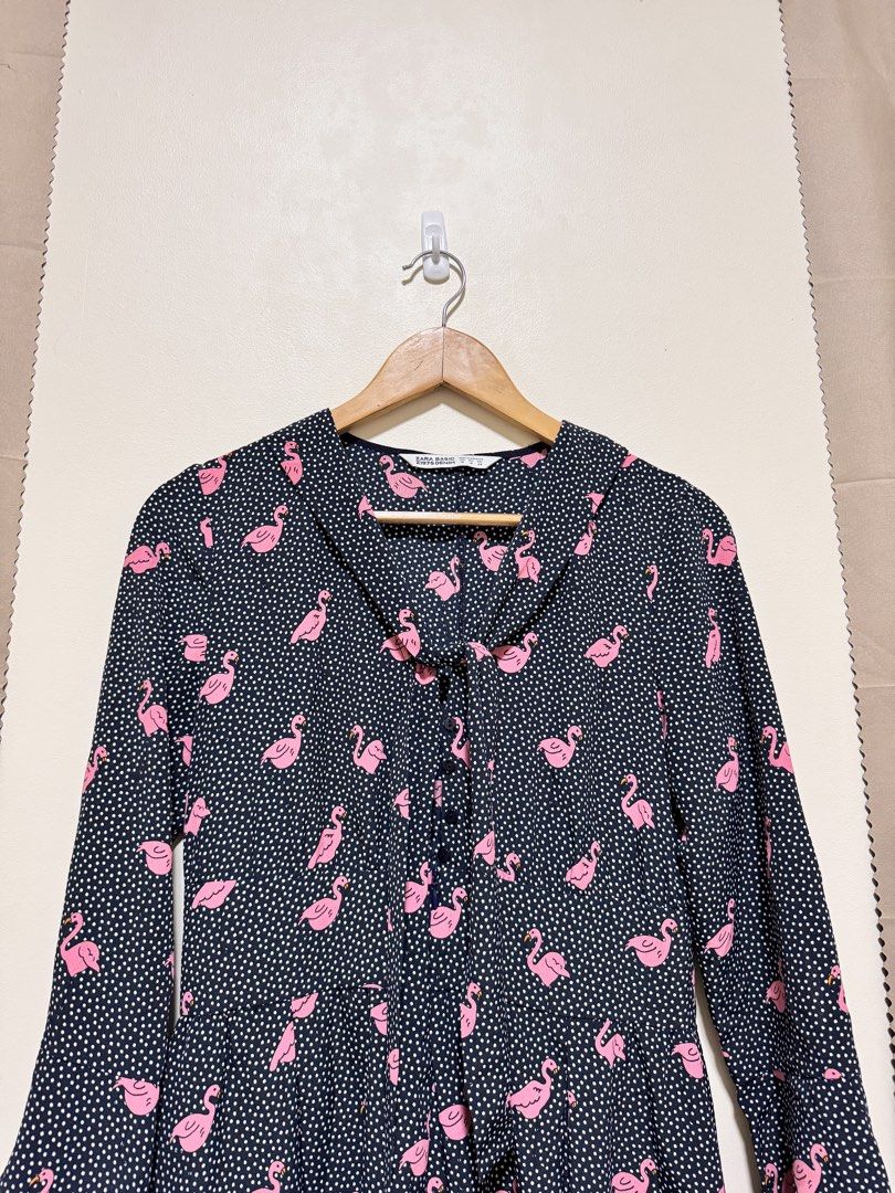 Zara Basic Romper (Category: Rompers) located in Manila. Submitted by seayouncey (Listing ID 1470067679, Image 3). Description: - Brand: Zara Basic Z1975 - Item: Denim Romper - Design: Dark navy blue with white polka dots and pink flamingo pattern - Features: Long sleeves, collared neckline with tie detail, front button placket - Fit: Relaxed fit shorts - Material: Lightweight fabric - Size: M - Condition: Great statement piece for casual outings