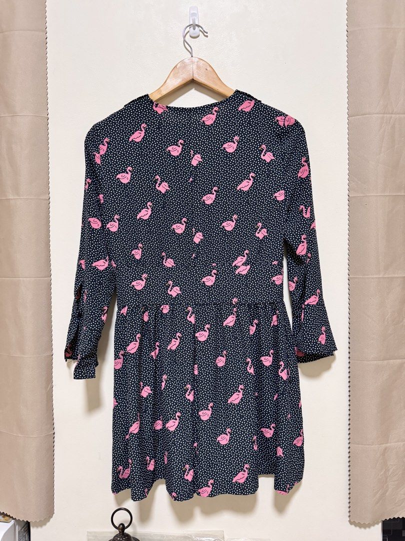 Zara Basic Romper (Category: Rompers) located in Manila. Submitted by seayouncey (Listing ID 1470067679, Image 2). Description: - Brand: Zara Basic Z1975 - Item: Denim Romper - Design: Dark navy blue with white polka dots and pink flamingo pattern - Features: Long sleeves, collared neckline with tie detail, front button placket - Fit: Relaxed fit shorts - Material: Lightweight fabric - Size: M - Condition: Great statement piece for casual outings