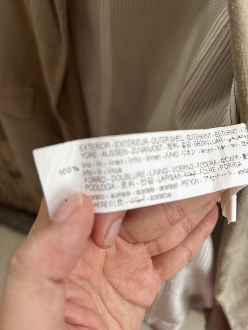 ZARA Beige Linen Blazer Size S (Category: Coats, Jackets and Outerwear) located in Taguig. Submitted by bestthriftxx (Listing ID 1470013157, Image 3). Description: - Brand: Zara - Material: 100% Linen (lightweight and breathable) - Color: Beige - Size: Small (S) - Design: Classic lapel collar, long sleeves, and two front flap pockets - Lining: Striped inner lining - Flaw Note: Minor yellow staining on the inside fabric near the bottom (does not a