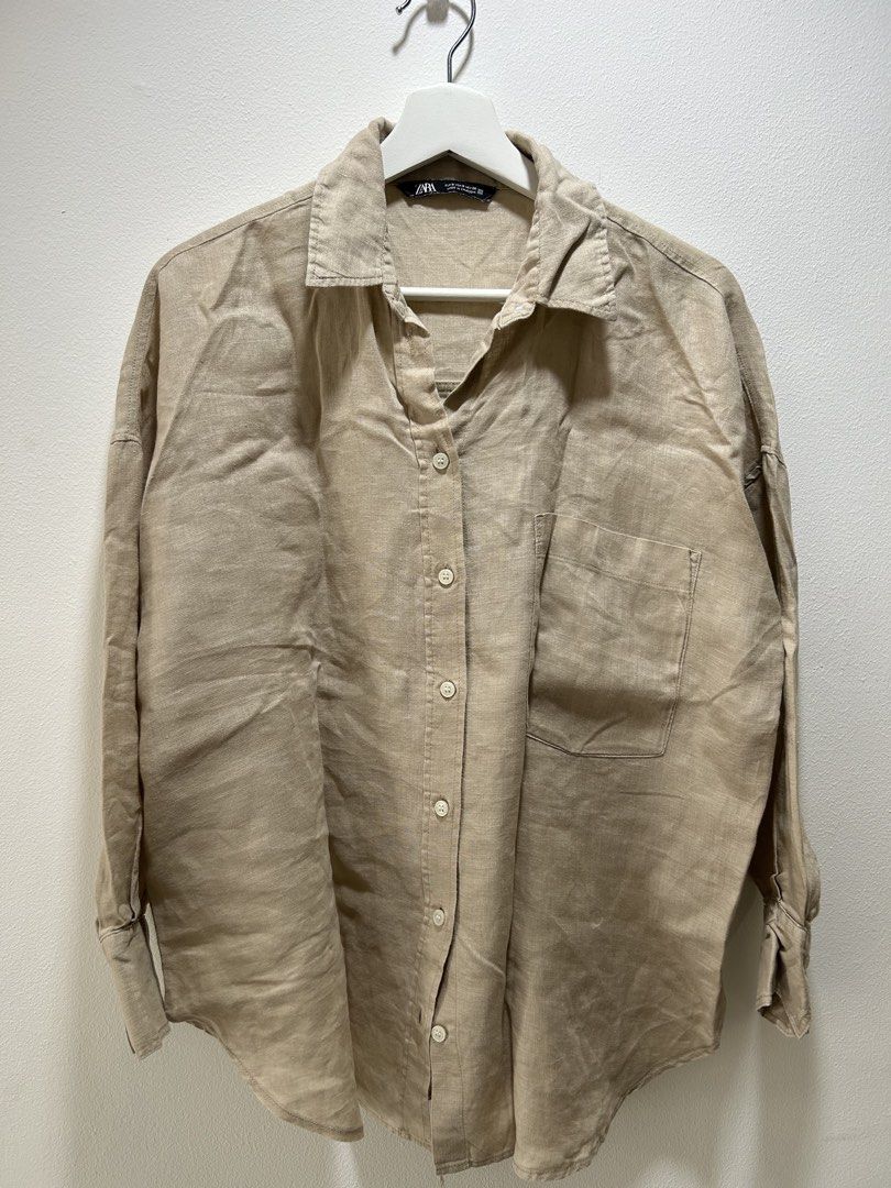 ZARA Beige Linen Long Sleeve Button-Down Shirt (Category: Longsleeves) located in Manila. Submitted by isabelle_1104 (Listing ID 1470026599, Image 1). Description: ZARA linen button-down shirt in beige. Classic collar, front button closure, single chest pocket. Long sleeves with button cuffs. Relaxed fit with a pleated back yoke detail. Lightweight and breathable fabric, great for layering or casual wear. Size S as indicated on the inner collar l