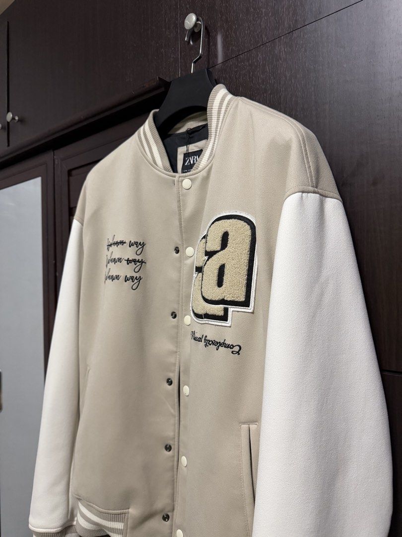 Zara Beige Varsity Bomber Jacket (Category: Coats, Jackets and Outerwear) located in Taguig. Submitted by jarellmrsgn (Listing ID 1470097344, Image 3). Description: - Brand: Zara - Condition: Like new - Color: Beige and white with black interior lining - Style: Varsity jacket with snap button closure .