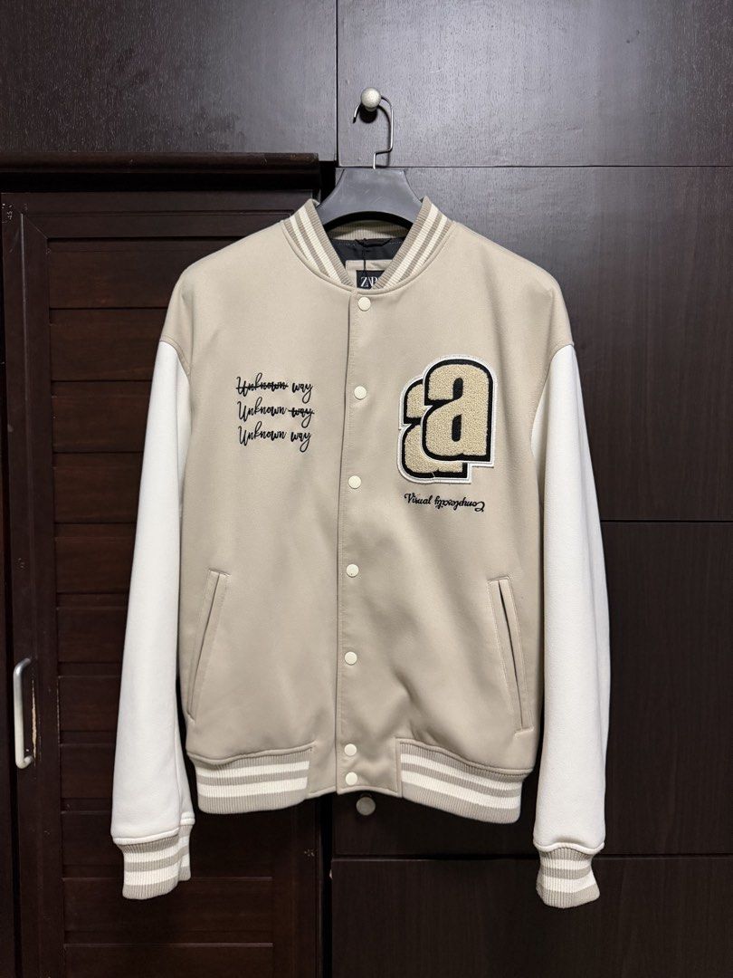 Zara Beige Varsity Bomber Jacket (Category: Coats, Jackets and Outerwear) located in Taguig. Submitted by jarellmrsgn (Listing ID 1470097344, Image 2). Description: - Brand: Zara - Condition: Like new - Color: Beige and white with black interior lining - Style: Varsity jacket with snap button closure .