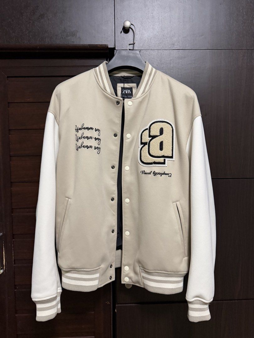 Zara Beige Varsity Bomber Jacket (Category: Coats, Jackets and Outerwear) located in Taguig. Submitted by jarellmrsgn (Listing ID 1470097344, Image 1). Description: - Brand: Zara - Condition: Like new - Color: Beige and white with black interior lining - Style: Varsity jacket with snap button closure .