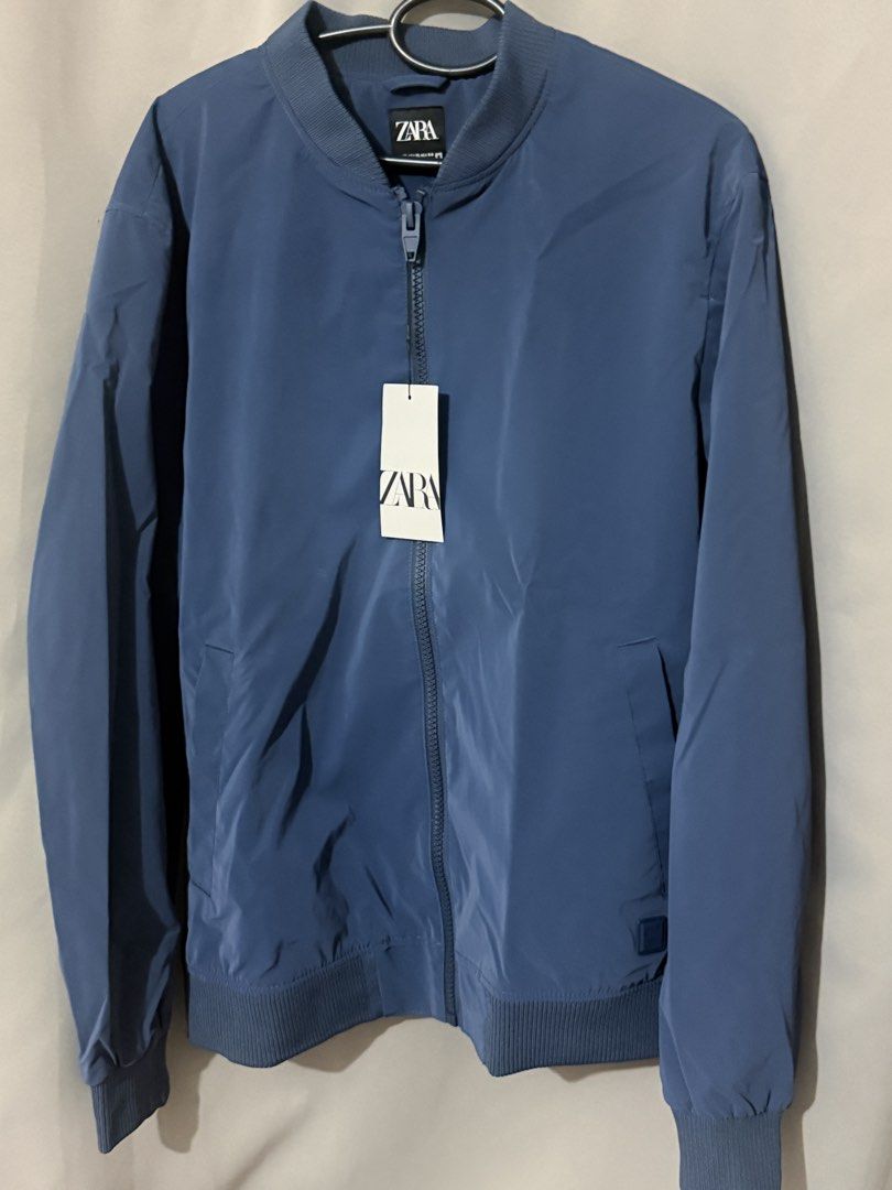 Zara Blue Bomber Jacket XL (Category: Coats, Jackets and Outerwear) located in Makati City. Submitted by joyjoytee (Listing ID 1470056291, Image 1). Description: - Brand: Zara - Style: Bomber jacket - Color: Blue - Size: XL (fits true to size) - Condition: Brand new with original tags, never worn - Features: Zip-up front, ribbed collar, cuffs, and hem, two side pockets - Origin: Made in Bangladesh.