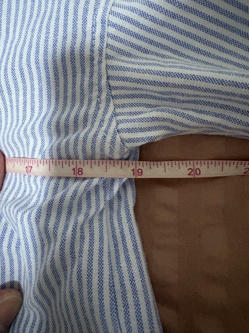 Zara Blue Striped Button-Up Shirt XS (Category: Longsleeves) located in Quezon City. Submitted by bluefrenchorn (Listing ID 1470070124, Image 3). Description: Zara blue and white striped button-down shirt. Classic collared neckline with long sleeves and button cuffs. Rounded hem at the bottom. Tag shows size XS. Measurements laid flat: pit to pit around 19 inches, length around 24 inches. Clean fabric, no flaws noticed..