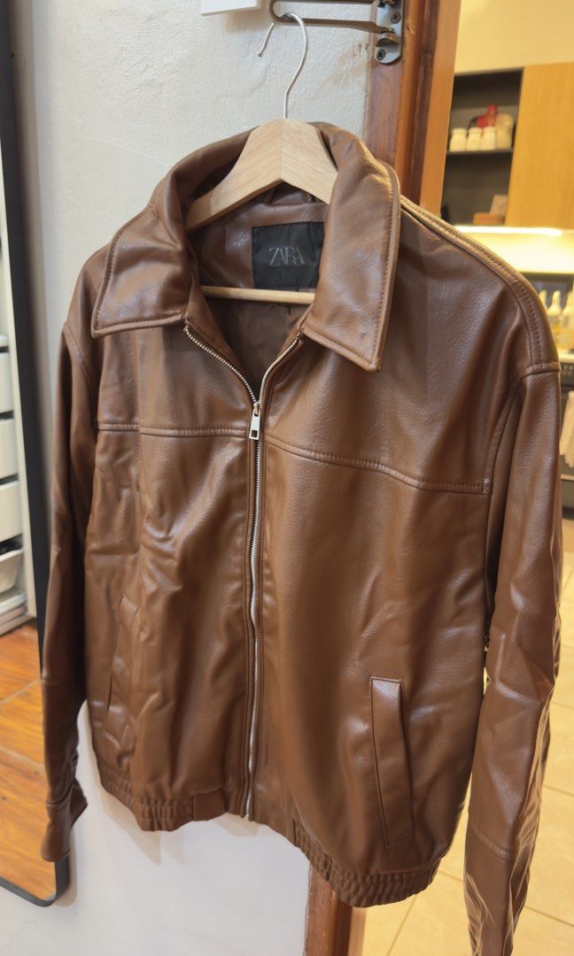 Zara Brown Leather Effect Bomber Jacket (Category: Coats, Jackets and Outerwear) located in Tuguegarao City. Submitted by bplacjoan30338 (Listing ID 1470050479, Image 2). Description: - Brand/Style: Zara leather effect bomber jacket - Color: Rich brown - Features: Classic collar, front zipper closure, ribbed hem, and side welt pockets - Details: Paneled sleeve design with button cuffs and a smooth finish - Fit/Use: Great everyday layering piece f