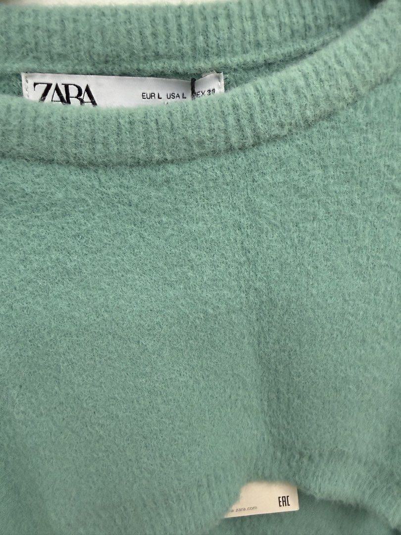 Zara Green Crop Sweater Size L (Category: Longsleeves) located in Quezon City. Submitted by reivia.vend (Listing ID 1469991110, Image 2). Description: - Brand: Zara - Size: L (Tag still attached) - Color: Green - Style: Crew neck, long sleeves, super short cropped cut - Texture: Soft knit - Perfect for: Layering over shirts or pairing with high-waisted bottoms.