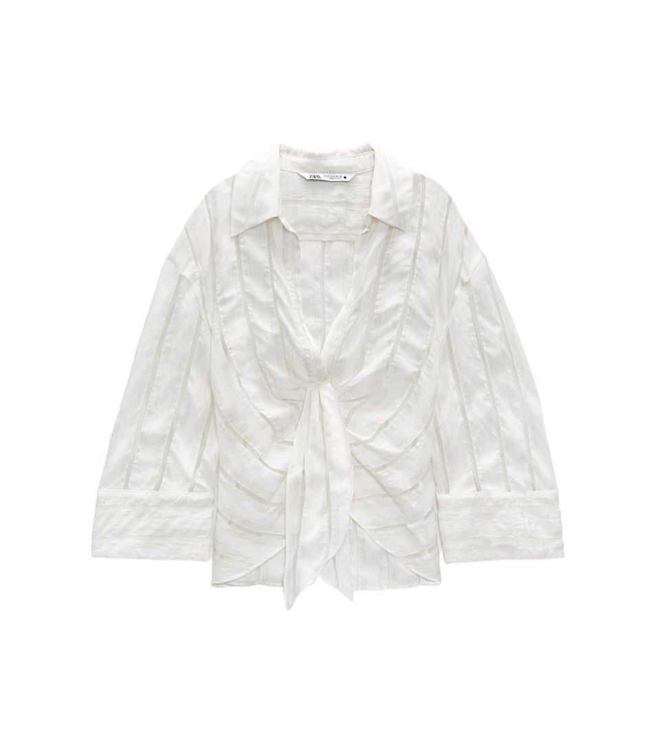 Zara pleated draped blouse large mango topshop T3 (Category: Blouses) located in San Pablo. Submitted by allyourbrandedneeds (Listing ID 1469969529, Image 1). Description: - Brand: Zara - Color: White with vertical sheer stripes - Details: Front knot tie, collar neckline, long sleeves with wide cuffs - Size: EUR L / USA L / MEX 30 - Made in: Turkey - Condition: Clean, excellent, ready to wear - Style: Great wardrobe staple for casual days or laye