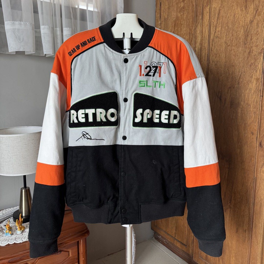 Zara Retro Speed Bomber Jacket Size M (Category: Coats, Jackets and Outerwear) located in Pura. Submitted by rarefindsph1205 (Listing ID 1470017329, Image 2). Description: - Brand: Zara - Style: Racing-style colourblock bomber jacket - Colourway: Black, orange, grey, and white - Details: 'RETRO SPEED' and 'BLANK CANVAS' patches on front and back - Closure: Snap button front - Trim: Ribbed collar, cuffs, and hem - Size: EUR M, USA M, MEX 40 - Orig