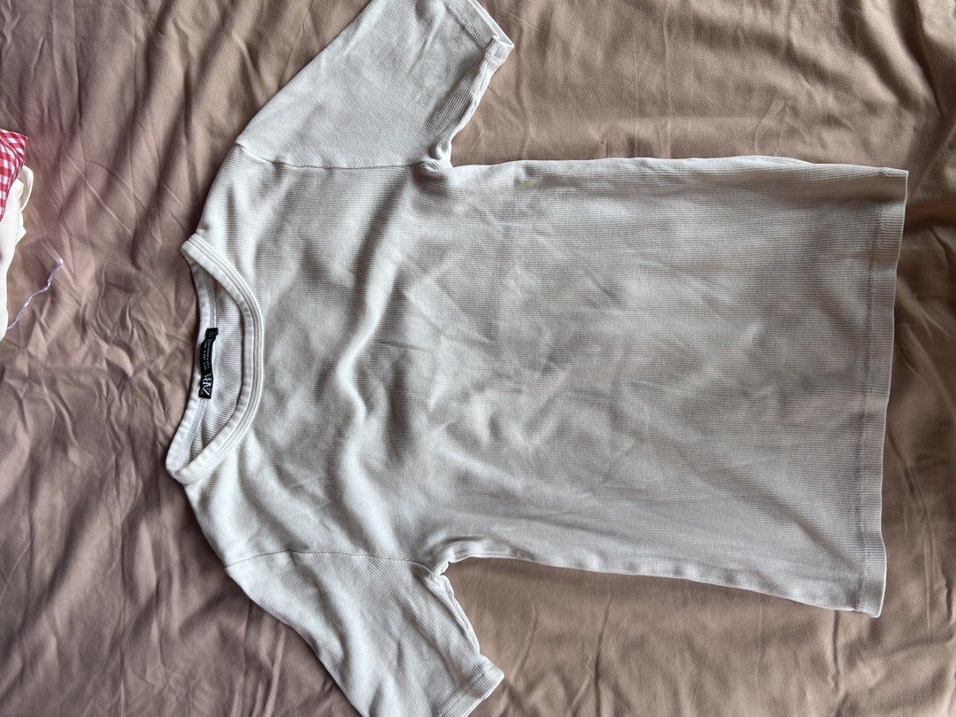 Zara Ribbed White T-shirt Size S (Category: Shirts) located in Cebu City. Submitted by shopmikascloset (Listing ID 1469956576, Image 3). Description: - Brand: Zara - Style: Ribbed crewneck basic tee - Color: White - Size: S (fits true to size) - Material: Stretchy, comfy cotton - Origin: Made in Bangladesh - Condition: Worn a few times, still in solid condition with lots of life left - Pairing: Easy to style with jeans or skirts.