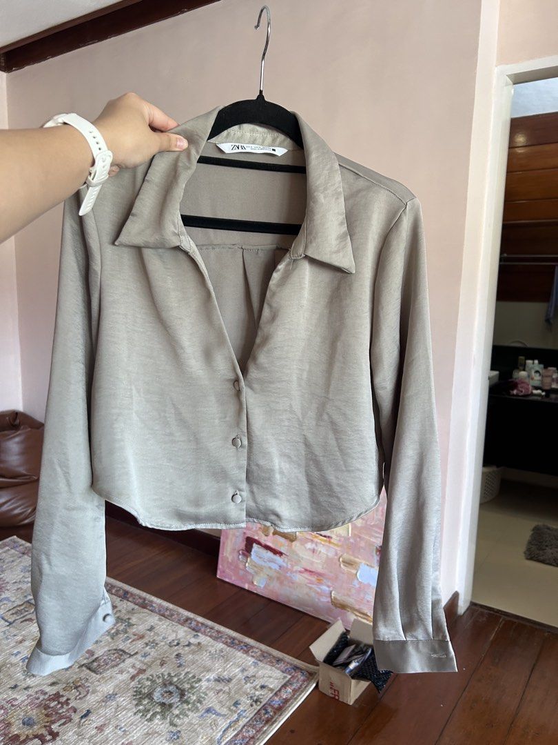 Zara Satin Long Sleeve Button Down Shirt (Category: Longsleeves) located in Cebu City. Submitted by shopmikascloset (Listing ID 1469956183, Image 2). Description: - Brand: Zara - Size: S (Made in Morocco) - Color: Greyish beige - Material/Finish: Satin with a nice sheen - Cut: Cropped with a curved hem - Features: Long sleeves with button cuffs and classic collar - Condition: Clean inside and out - Styling: Easy to dress up with trousers or keep 