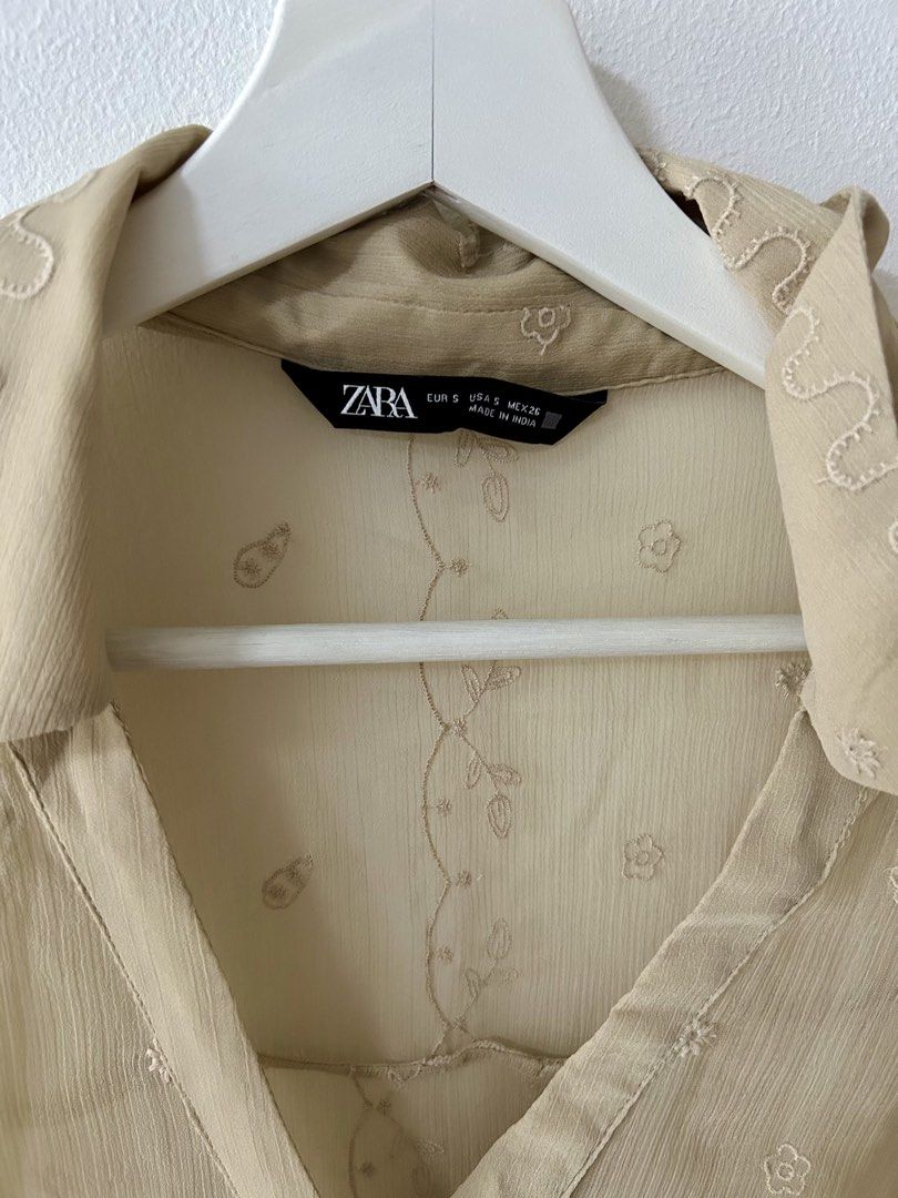 Zara Sheer Embroidered Beige Button-Down Shirt (Category: Blouses) located in Manila. Submitted by isabelle_1104 (Listing ID 1469967095, Image 3). Description: - Brand: Zara - Size: S - Color: Beige sheer - Details: Scattered floral embroidery, wavy pattern on collar and cuffs, classic collar, long sleeves with button cuffs - Material: Light and breathable fabric - Origin: Made in India - Condition: Excellent.