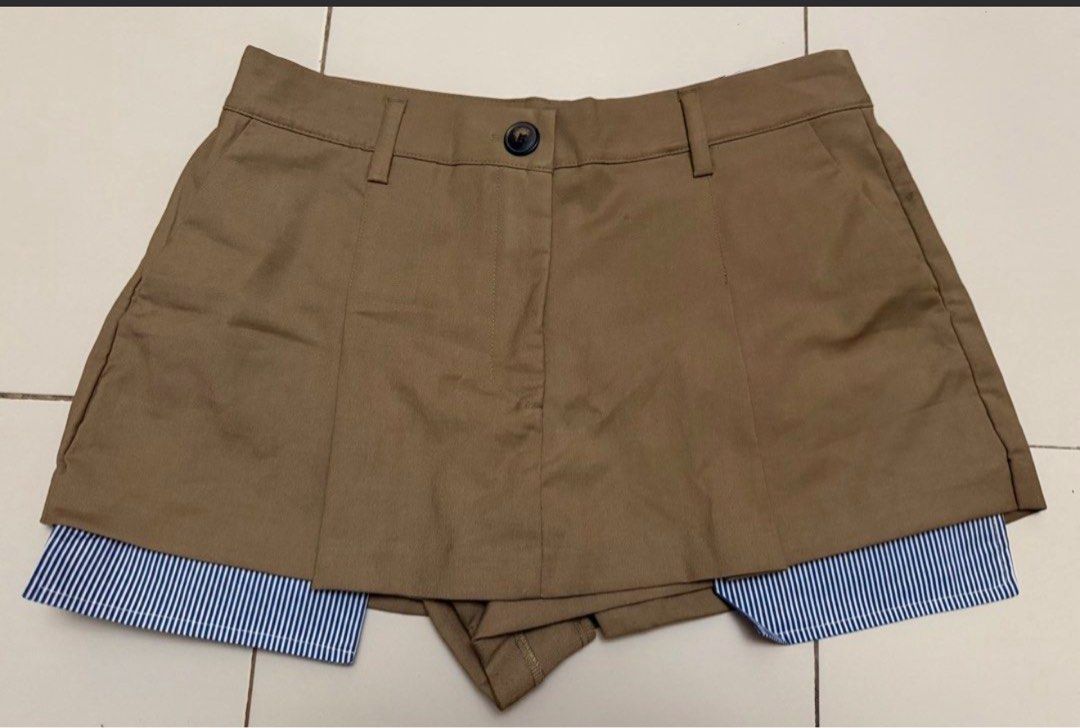 Zara Skort Brown Striped Layer Size M (Category: Shorts) located in Marikina City. Submitted by kcaps.declutter (Listing ID 1470005800, Image 1). Description: - Brand: Zara - Condition: Brand new with tags attached, never worn - Color: Khaki brown with blue and white striped inner layer - Style: Double-layered skort with front button closure, belt loops, and inner shorts - Fit: Comfortable and secure front flap construction - Size: 30 Courier: la