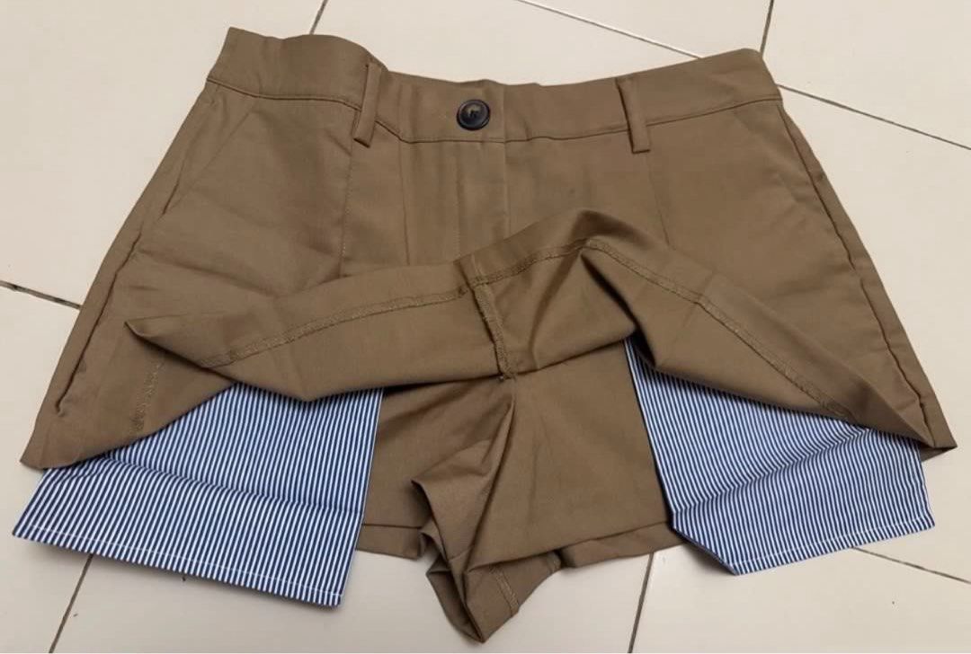 Zara Skort Brown Striped Layer Size M (Category: Shorts) located in Marikina City. Submitted by kcaps.declutter (Listing ID 1470005800, Image 3). Description: - Brand: Zara - Condition: Brand new with tags attached, never worn - Color: Khaki brown with blue and white striped inner layer - Style: Double-layered skort with front button closure, belt loops, and inner shorts - Fit: Comfortable and secure front flap construction - Size: 30 Courier: la
