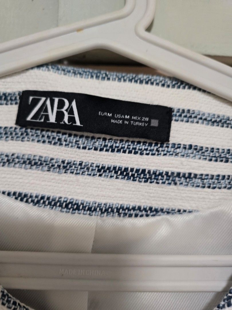 Zara Striped Crop Blazer Size M (Category: Coats, Jackets and Outerwear) located in Paranaque City. Submitted by jasminepc (Listing ID 1469967511, Image 3). Description: last price posted see flaw on last two pictures. can be managed by lint remover and cleaning the button. - Brand: Zara - Size: Medium - Color/Pattern: Blue and white striped - Material: Textured woven fabric with fully lined interior - Details: Gold-tone front buttons, faux pocke