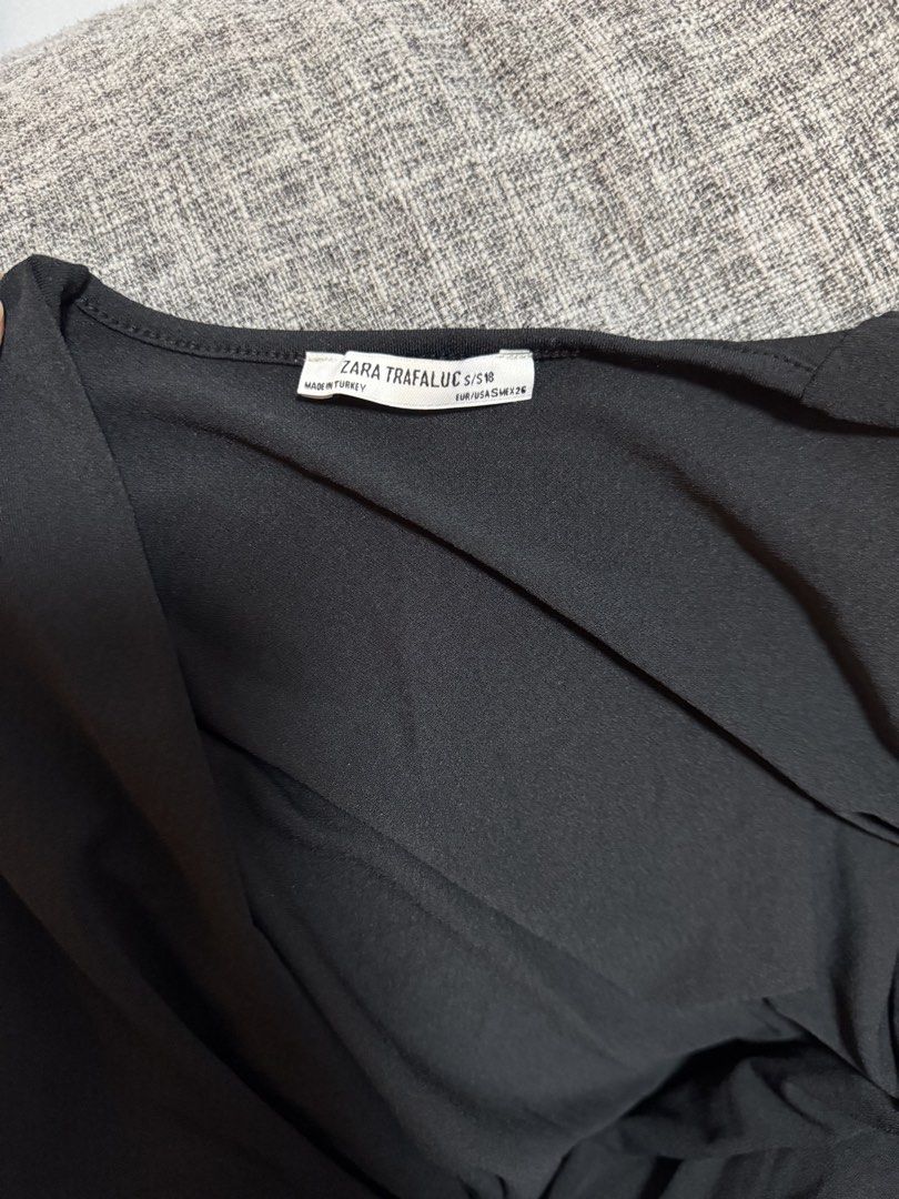 Zara Trafaluc Black Draped Bodysuit Size S (Category: Sleeveless) located in Calamba. Submitted by cheriiv (Listing ID 1469949756, Image 2). Description: With tiny pinholes in front since I put safety pin - Brand: Zara Trafaluc - Style: Sleeveless bodysuit with deep draped V-neck and gathered shoulders - Size: S - Material: Soft, stretchy, and comfortable fabric.