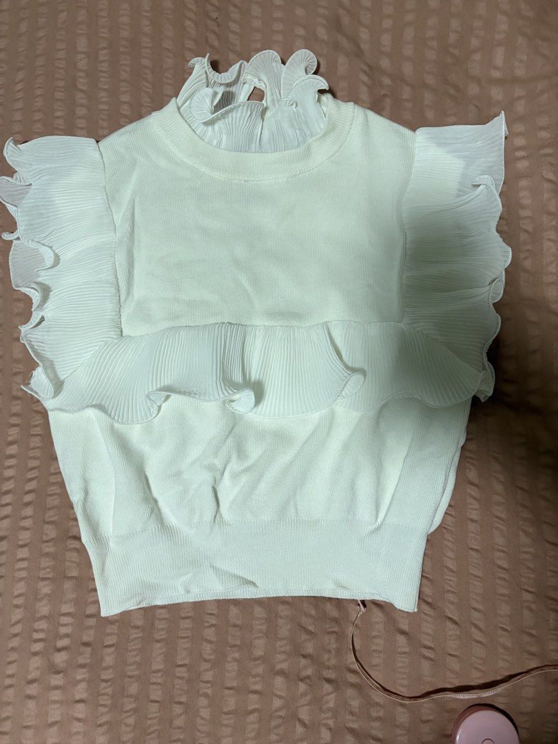 Zara White Ruffle Knit Top Size S (Category: Sleeveless) located in Quezon City. Submitted by bluefrenchorn (Listing ID 1470069350, Image 1). Description: White knit top from Zara. Size S. Features layered pleated ruffles on the shoulders and upper chest, plus pleated high collar. Ribbed texture throughout the body. Measurements: pit to pit roughly 14.5 inches, length about 15.5 inches. Fabric includes polyamide blend. Clean condition, tags attac