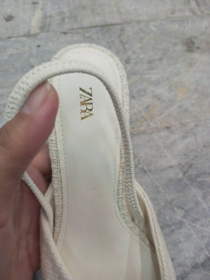 Zara White Slingback Kitten Heels Size 36 (Category: Heels) located in Bay. Submitted by silverhorse-59c851 (Listing ID 1470087234, Image 2). Description: - Brand: Zara - Style: Slingback low kitten heels with slip-on design - Color & Texture: White textured fabric - Details: Pointed toe with elegant gold button accent - Size: 36 - Condition: Clean with minimal wear on the soles.