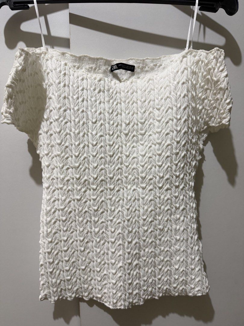Zara White Textured Off-Shoulder Top (Category: Blouses) located in Manila. Submitted by xoxorml (Listing ID 1470049575, Image 1). Description: - Brand: Zara - Color: White - Size: Small - Material: Stretchy, body-hugging knit fabric - Design: Textured popcorn pattern all over - Features: Short sleeves, off-shoulder boat neckline.