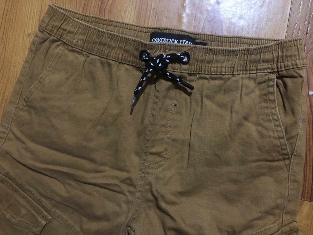 12y Sovereign State Brown Cargo Shorts (Category: Babies & Kids Fashion) located in Quezon City. Submitted by lexipotpot (Listing ID 1470173083, Image 3). Description: - Brand: Sovereign State - Color: Versatile brown - Waist: Elastic with adjustable black & white speckled drawstring - Pockets: Practical side cargo pockets with button flaps, plus standard front and back pockets - Material: Comfortable and breathable cotton-blend fabric - Can fit 