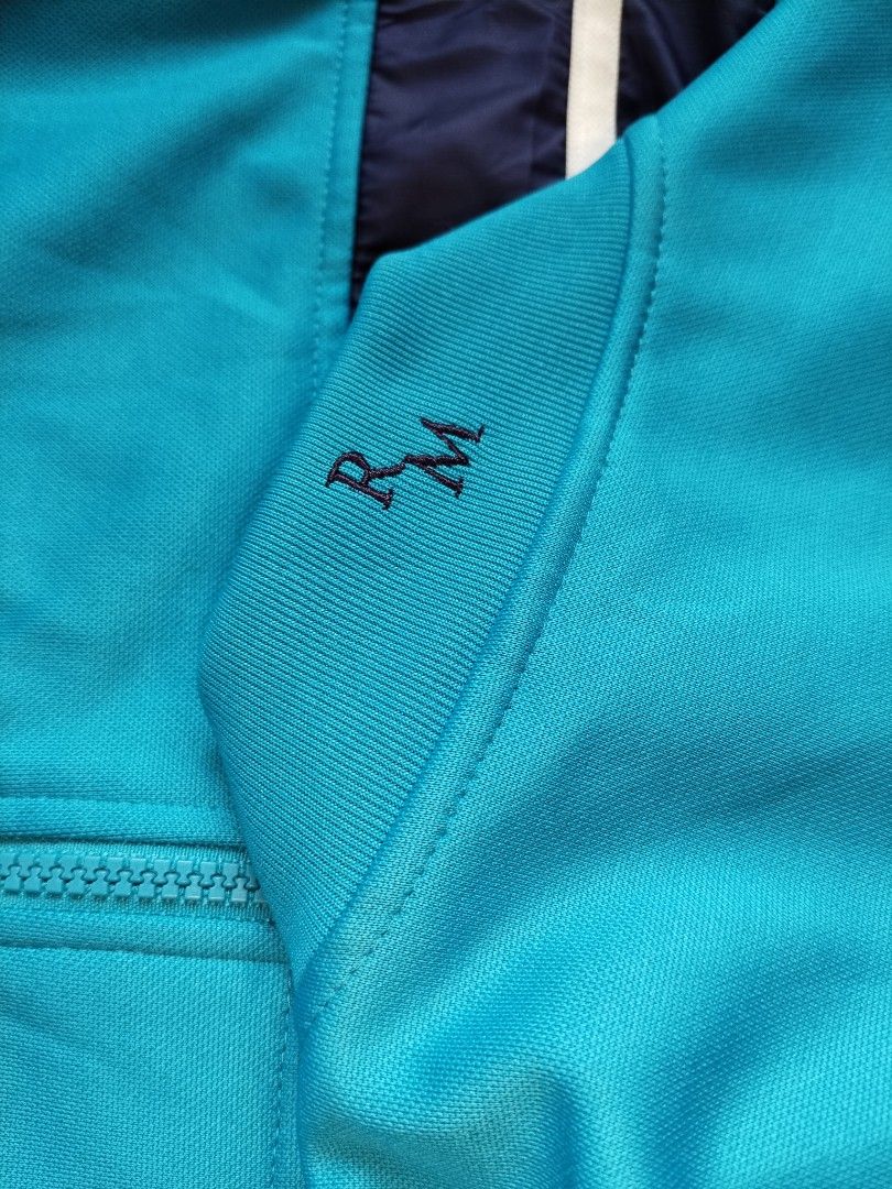 2012 Adidas Real Madrid Track Jacket (Category: Coats, Jackets and Outerwear) located in Pasig City. Submitted by loveforlux_2025 (Listing ID 1470236958, Image 3). Description: - Authentic Adidas Real Madrid track jacket in bright blue - Features embroidered club crest and classic Adidas logo - Navy blue mid-section with white stripe detail and iconic 3-stripes on sleeves - Full zip front with secure zippered pockets - Size: 105 (Made in Vietnam)