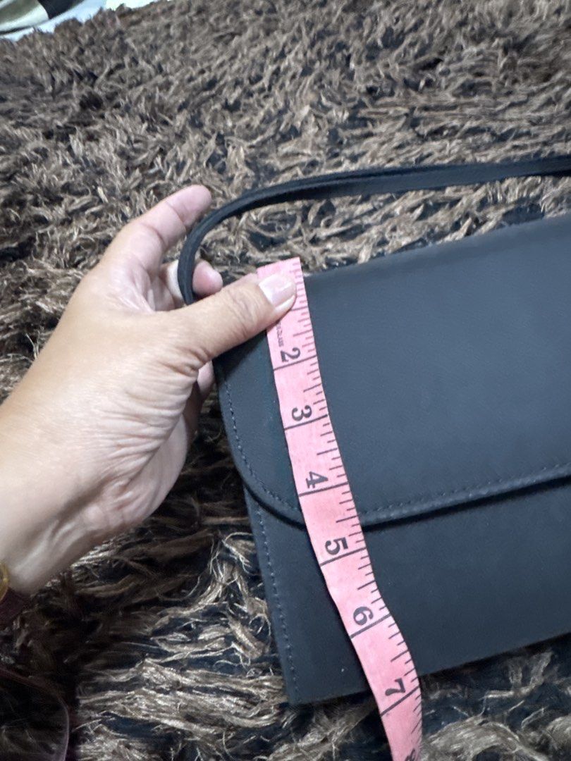 2027 WST Black structured handbag with top handle (Category: Tote Bags) located in Silang. Submitted by sari2bilina (Listing ID 1470176703, Image 2). Description: - Color & Material: Elegant black satin - Closure: Secure flap closure - Handle: Single top handle for easy carrying - Interior: Clean dark fabric lining with a convenient inner pocket slot - Dimensions: Structured shape, approx. 5 inches high and 3 inches wide at the bottom - Condition