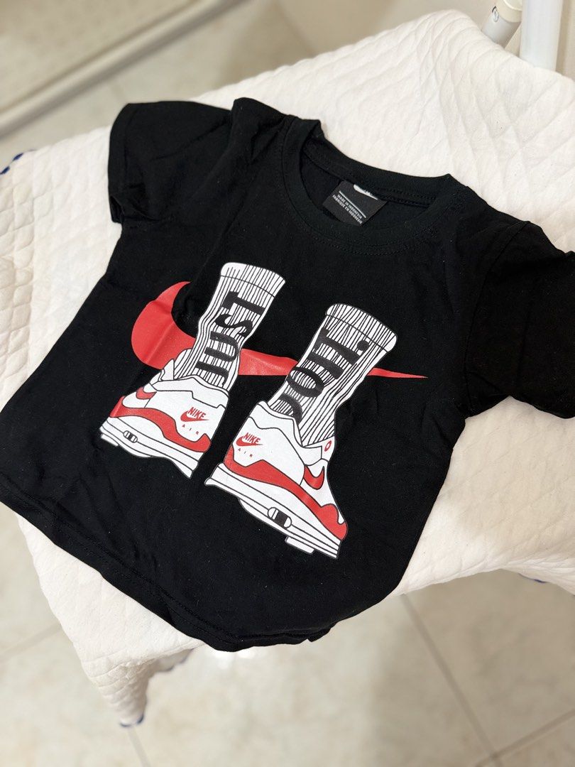 2Pcs Nike Sneaker Graphic Tee Bundle White Black (Category: Babies & Kids Fashion) located in Manila. Submitted by aaayana123 (Listing ID 1470228696, Image 2). Description: - Bundle of 2 Nike graphic t-shirts - Colors: White (sneaker collage print with upside-down logo) and Black (red swoosh and sock sneaker graphic) - Classic crew neck and short sleeves - Made from soft, comfortable cotton material - Ideal everyday casual streetwear for sneaker 