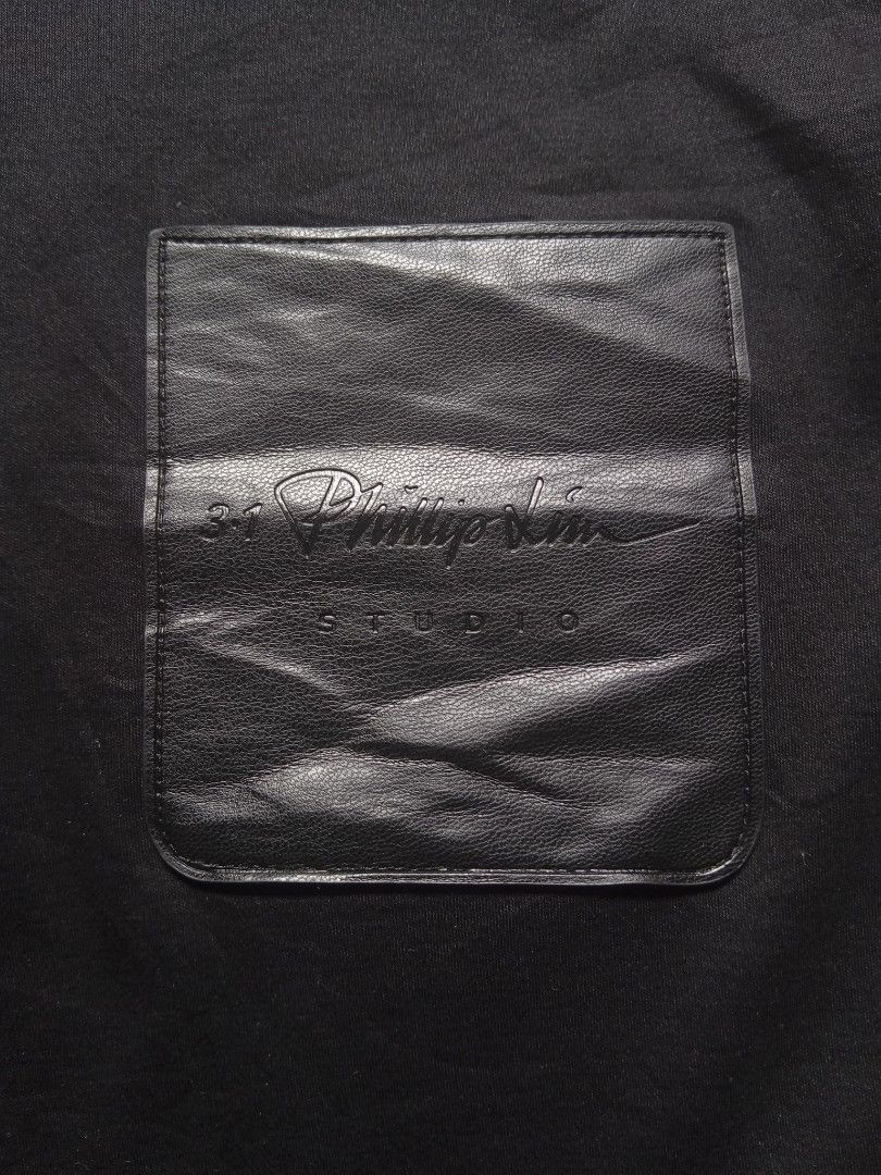 3.1 Philip Lim leather pocket stamped logo tee (Category: Luxury Apparel) located in Davao. Submitted by hisdef (Listing ID 1470163921, Image 3). Description: Philip Lim leather pocket stamped logo tee Condition- like new issue- none color - black 10/10 Dimensions in inches width-23 length-19.