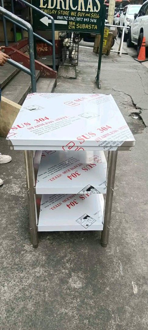 3-Tier Stainless Steel Utility Table Prep Work Bench 80x60x80cm (Category: Tables & Sets) located in Manila. Submitted by mightytiger_4bb6fd (Listing ID 1470218219, Image 1). Description: - Type: 3-tier heavy-duty stainless steel utility table - Condition: Brand new and unused, protective plastic film still on shelves and top - Build: Sturdy metal legs and frame for maximum durability - Versatile Use: Ideal for kitchen prep, workshop storage, or 