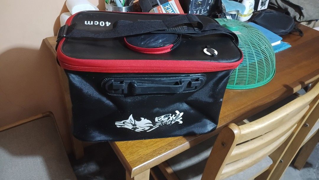 40cm EVA Foldable Fishing Tackle Bag (Category: Fishing) located in San Ildefonso. Submitted by rigor32eva20161 (Listing ID 1470167542, Image 2). Description: - Size: 40cm fishing tackle storage bag in stylish black and red - Material: Premium waterproof EVA for ultimate gear protection - Design: Built-in front handle and sturdy top shoulder strap for easy carrying - Organization: Includes a zippered mesh pouch on the lid for small accessories - 