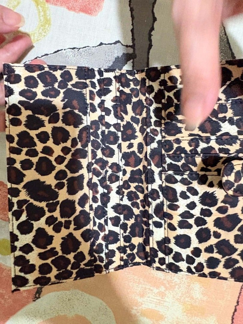 : [VINTAGE] 2001 Sanrio Hello Kitty Leopard Print Tri-fold Wallet (Category: Wallets & Card holders) located in Quezon City. Submitted by peachhalves (Listing ID 1470148271, Image 2). Description: Rare authentic vintage 2001 Sanrio Hello Kitty tri-fold wallet/pouch featuring a classic leopard/cheetah print pattern with mini Hello Kitty details. Perfect for Y2K aesthetic lovers and Sanrio collectors! ✨ Condition: Like New (Excellent vintage condit