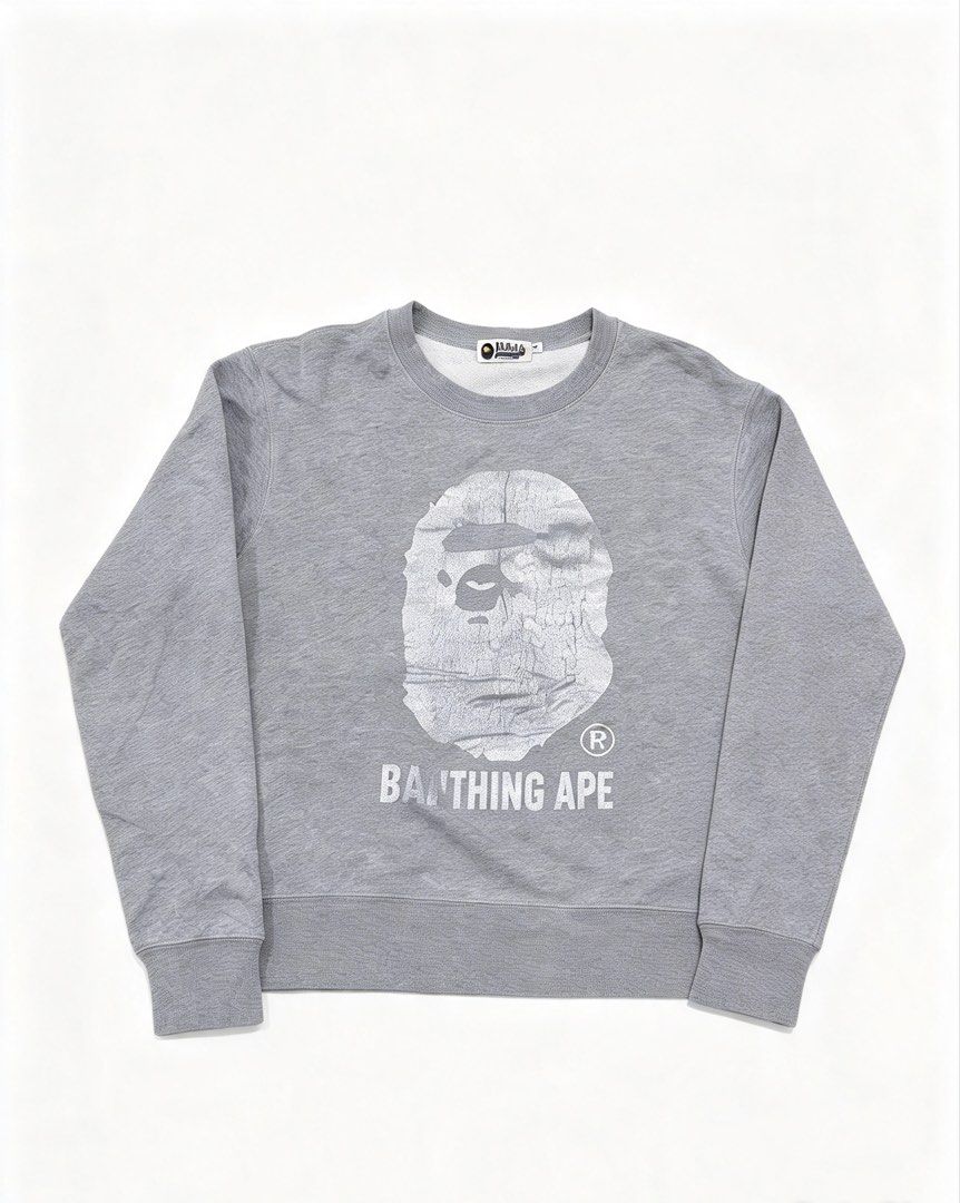 A Bathing Ape BAPE Ape Head Grey Sweatshirt Size M (Category: Coats, Jackets and Outerwear) located in Caloocan City. Submitted by jerichotad22965 (Listing ID 1470195038, Image 1). Description: - Brand: A Bathing Ape (BAPE) - Item: Grey Cotton Sweatshirt - Size: Medium - Design: Distressed ape head graphic with 'By Bathing Ape' lettering - Authenticity details: Interior wash tags and golden ape sleeve tag included - Style: Classic streetwear esse
