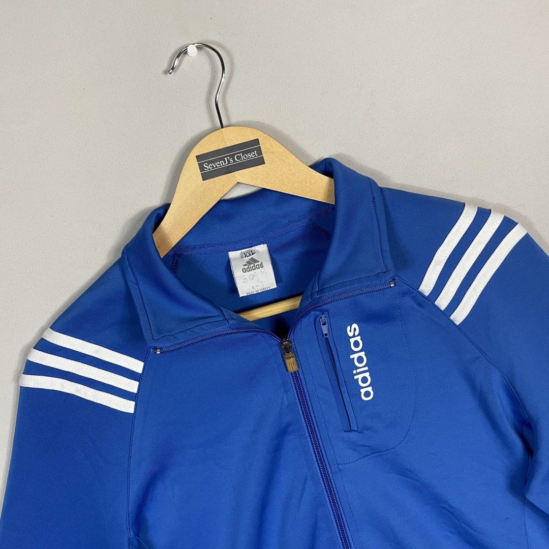 A D I D A S | Royal Blue Adidas Full-Zip Track Jacket (Category: Coats, Jackets and Outerwear) located in Norzagaray. Submitted by sevenjscloset (Listing ID 1470257552, Image 2). Description: Royal blue full-zip track jacket from Adidas. - White three-stripe branding on the shoulders and cuffs. - Vertical zippered chest pocket with Adidas lettering print. - Tagged size XXL, measures 21.5 inches in length and 18 inches in width. - Model in photos 