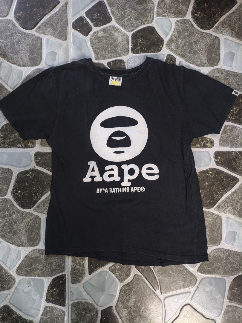 Aape By A Bathing Ape Black T-Shirt (Category: Tshirts & Polo Shirts ) located in Narvacan. Submitted by picky_looter (Listing ID 1470299140, Image 1). Description: - Brand: Aape by A Bathing Ape - Color: Classic Black - Size: XL - Material: 100% Cotton, Made in Japan - Design: Large white ape head graphic on front with text - Details: Small ape logo on back collar and sleeve tag - Fit: Regular crew neck, short sleeve.